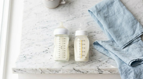 Comparatif de biberons en verre et en plastique sans BPA posés sur un plan de travail propre | Securidou